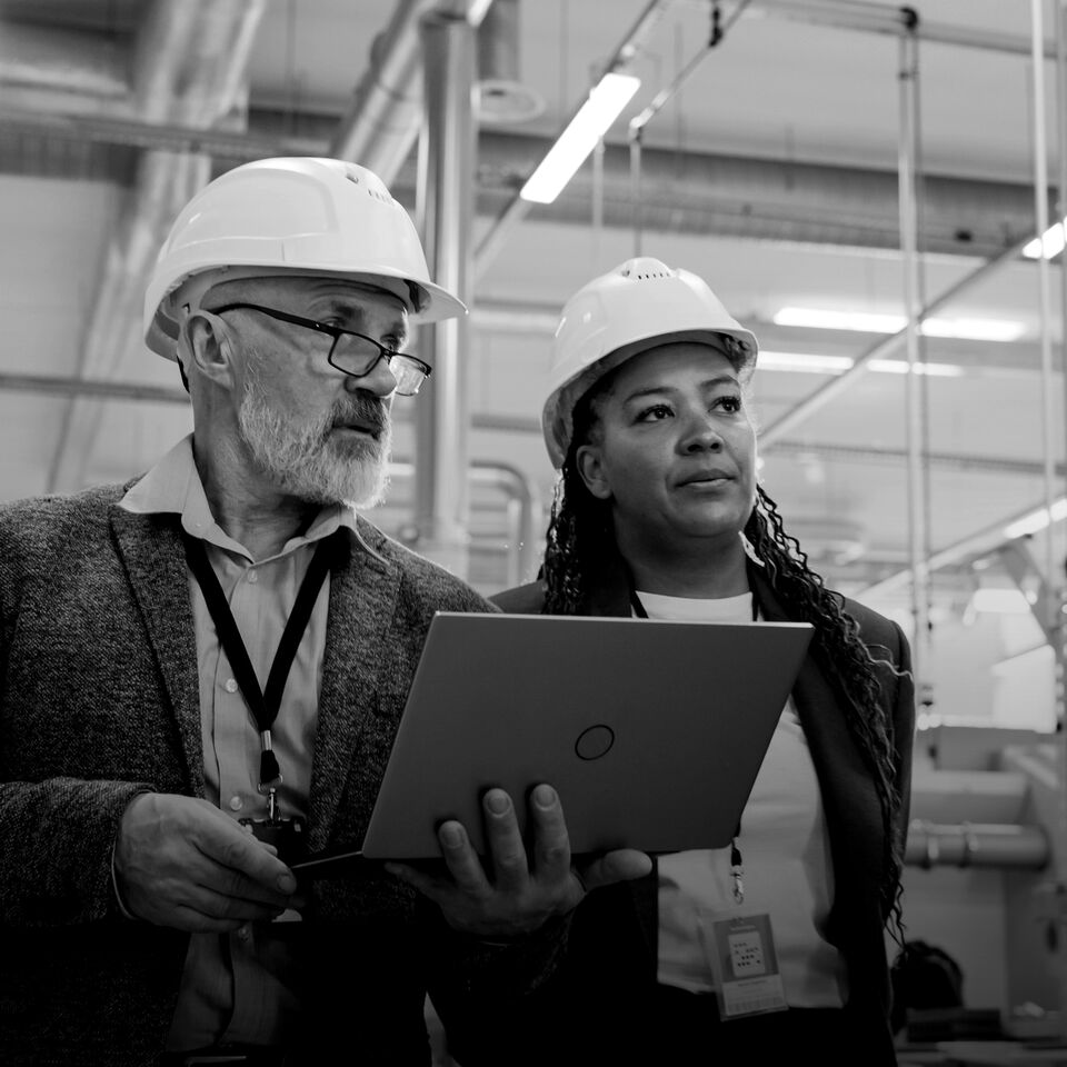 SINGLE-IMAGE_male-and-female-with-hard-hats-holding-laptop-no-squares_mar24