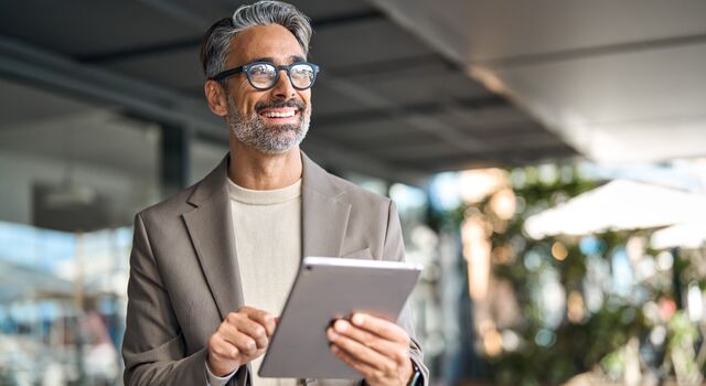 COLOUR IMAGE_businessman_on_tablet_Jun26
