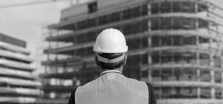SINGLE-IMAGE_construction-worker-facing-building-site_may25