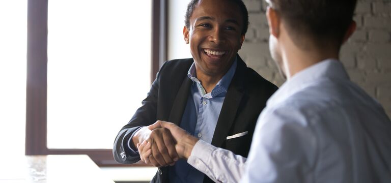 /bynder-asset/bynder:180703A7-A1DF-43F3-A5A11E96F58DB841/Landscape_MD/COLOUR-IMAGE_men-shaking-hands-smiling-zoomed_feb26.jpg?1773752927000