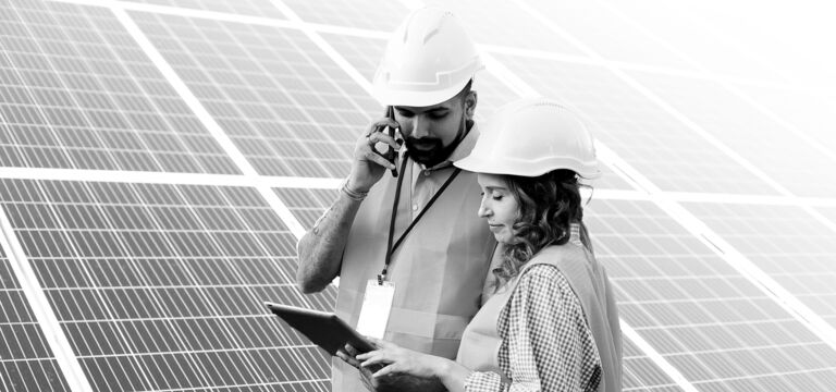 SINGLE-IMAGE_two-workers-hard-hats-tablet-solar-panels_nov23