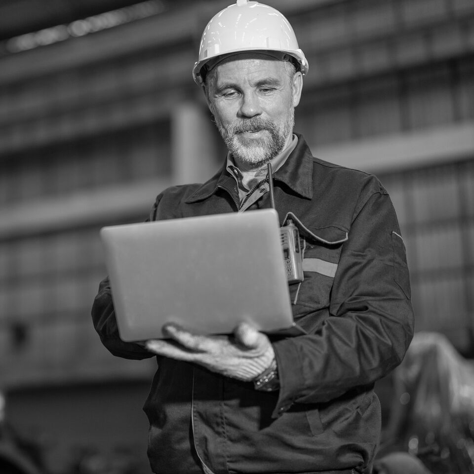 SINGLE-IMAGE_senior-male-engineer-wearing-white-hard-hat-and-safety-gloves_jul25