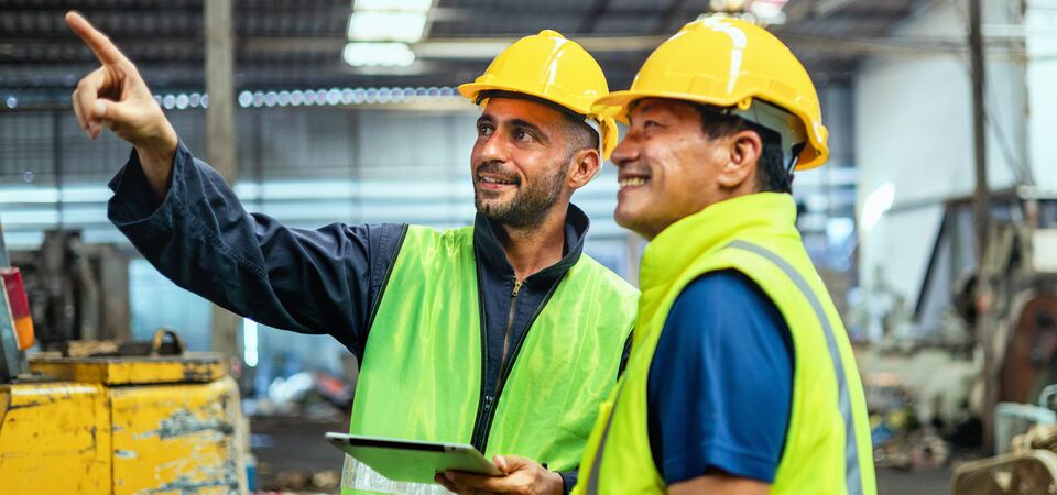 COLOUR-IMAGE_two-men-looking-at-fixture-in-factory_apr26