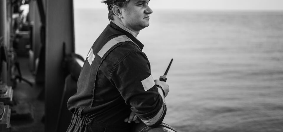 SINGLE-IMAGE_male-engineer-on-deck-holding-walkie-talkie_jul24