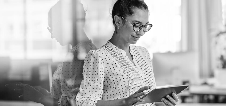 SINGLE-IMAGE_businesswoman-using-a-digital-tablet-in-an-office_may25