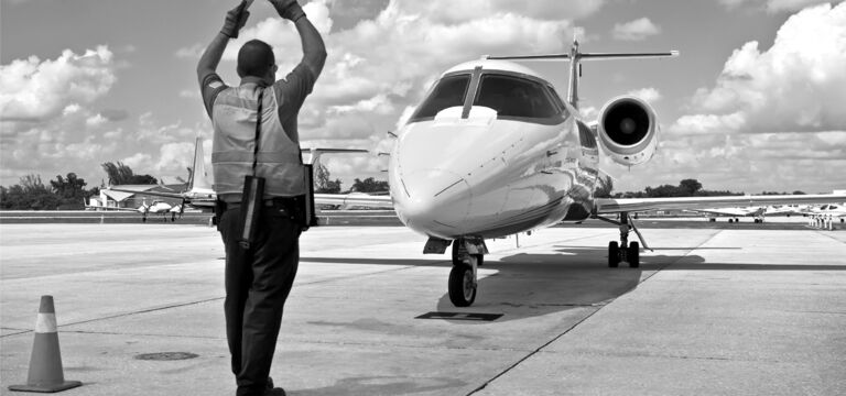 SINGLE-IMAGE_air-traffic-marshall-with-jet_nov23