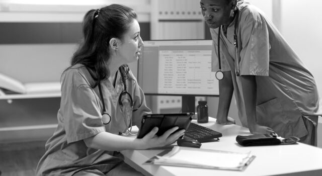 SINGLE-IMAGE_two-nurses-talking-over-tablet_sept24