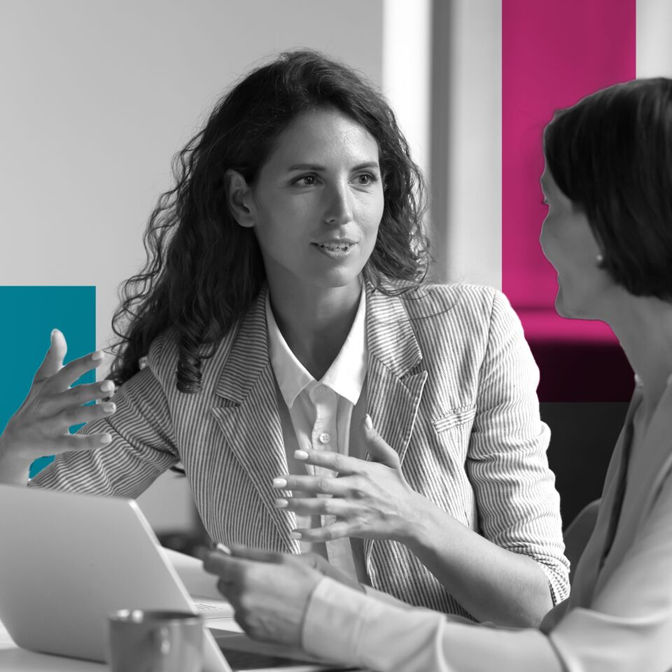 SINGLE-IMAGE_squares-two-business-women-sit-at-desk-laptop_jul24